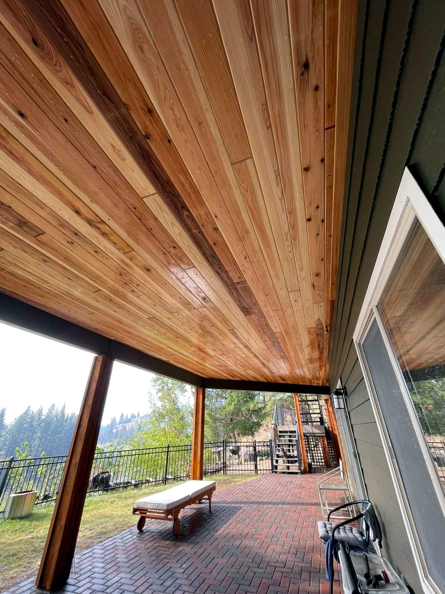Tongue-and-groove cedar ceiling over a covered patio at dusk