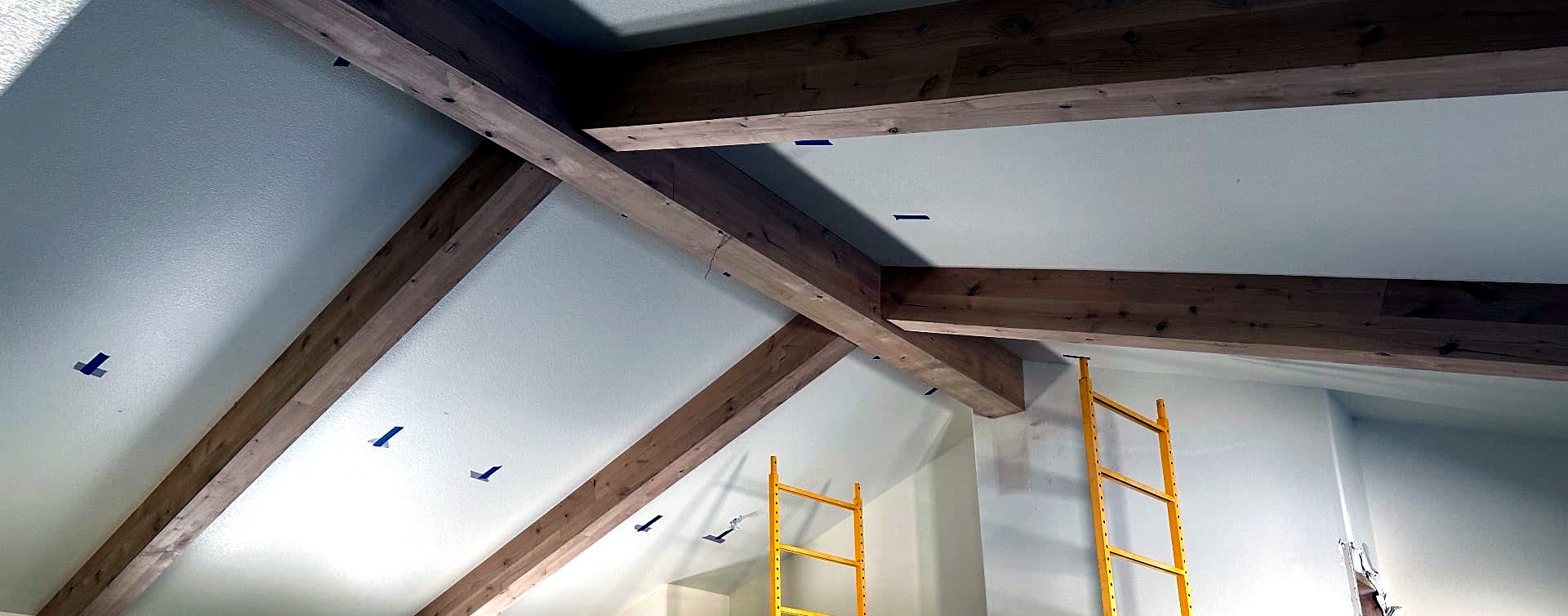 Douglas fir ceiling beams crossing a vaulted ceiling in a living room